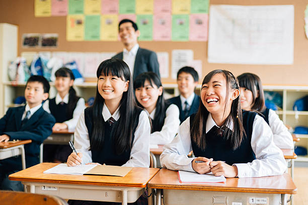 Japanese Junior High School students laughing at a funny presentation or performance in class